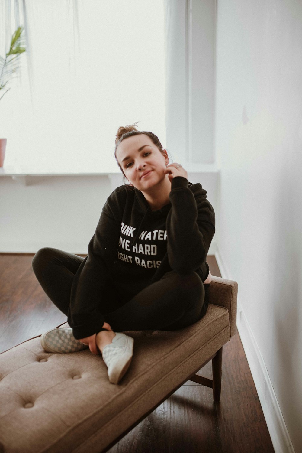 a woman sitting on a bench in a room