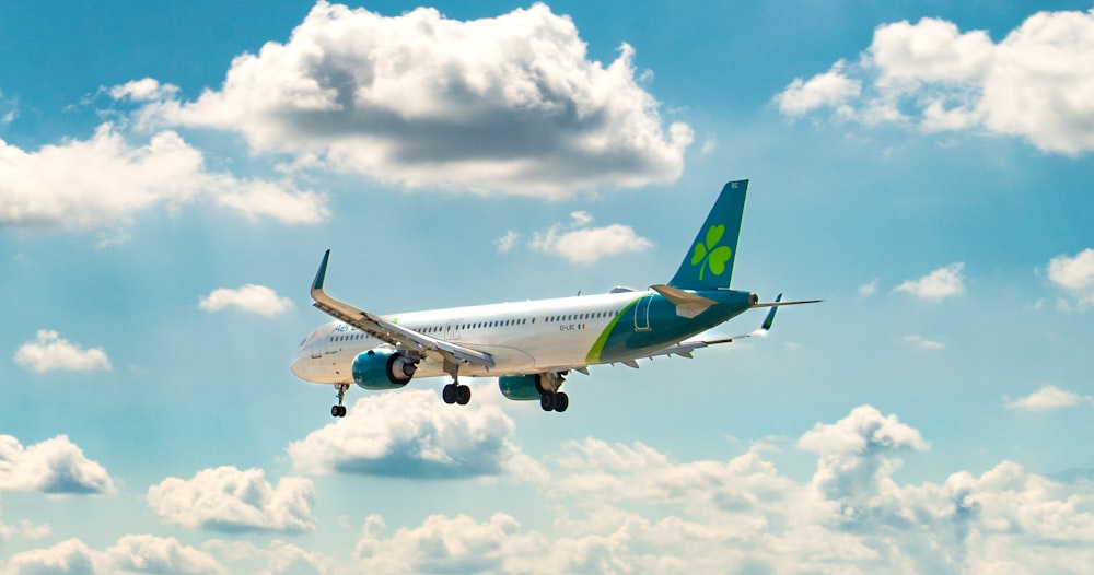 a large jetliner flying through a cloudy blue sky