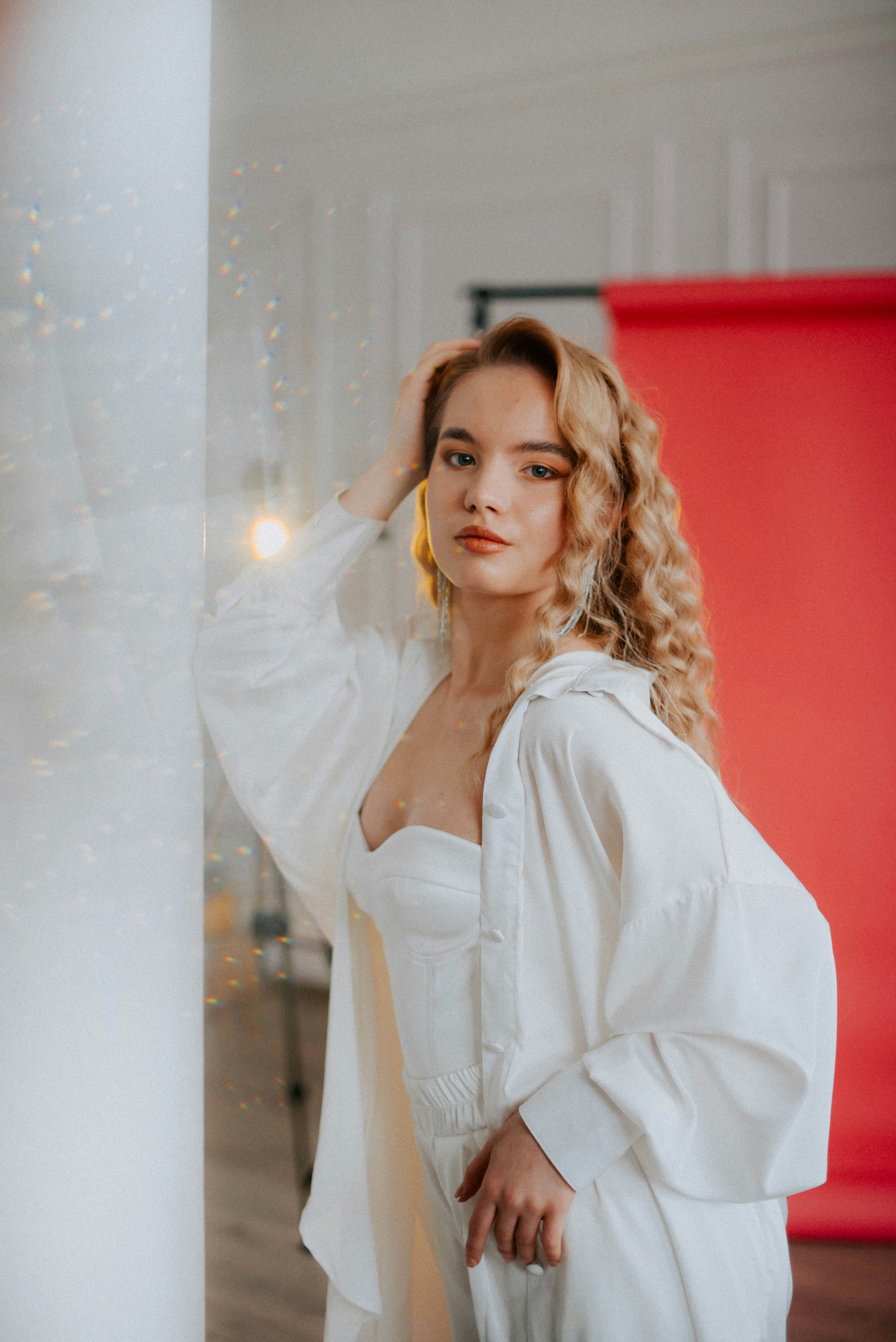 a woman in a white dress is posing for a picture