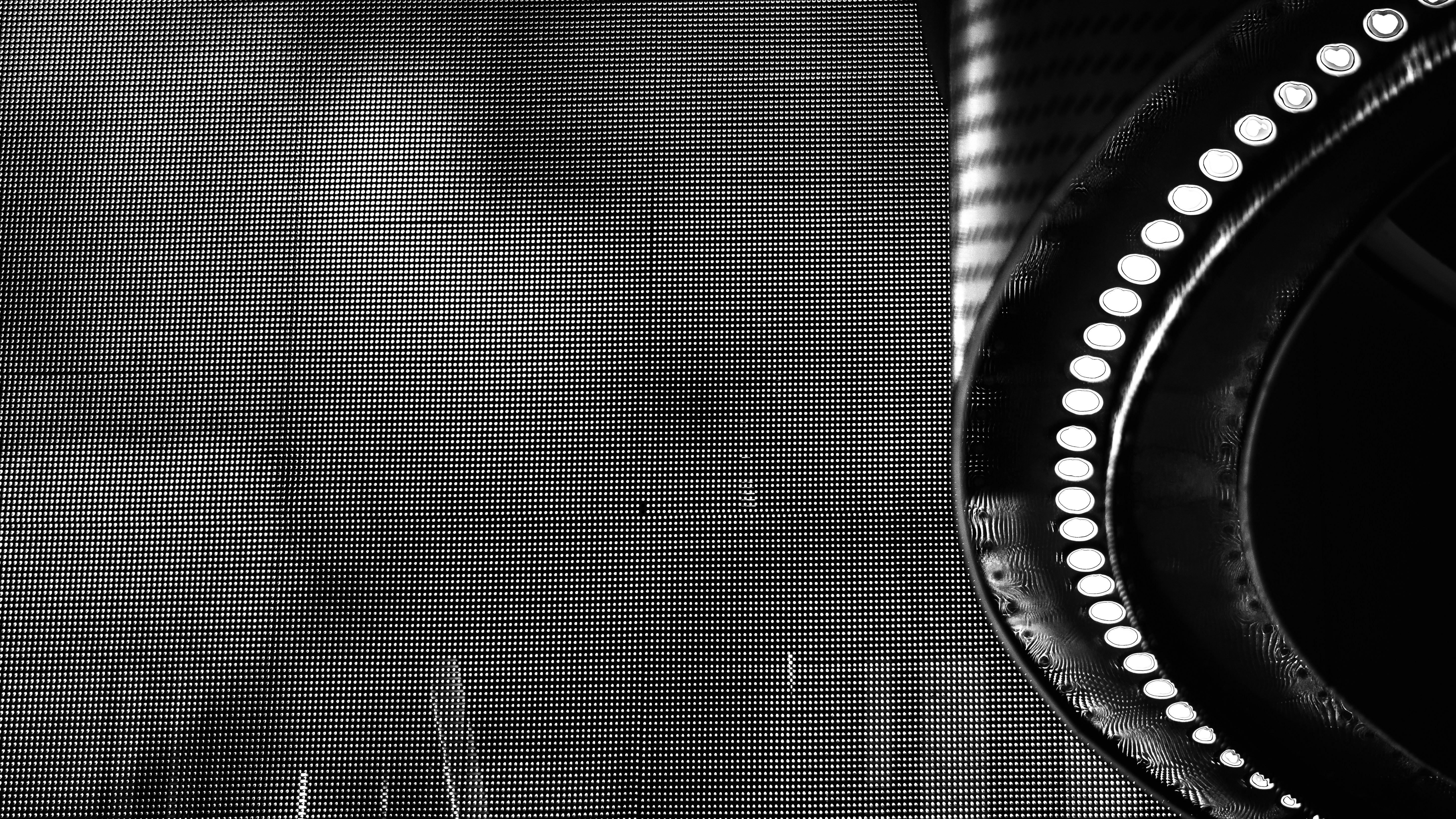 a black and white photo of a round mirror