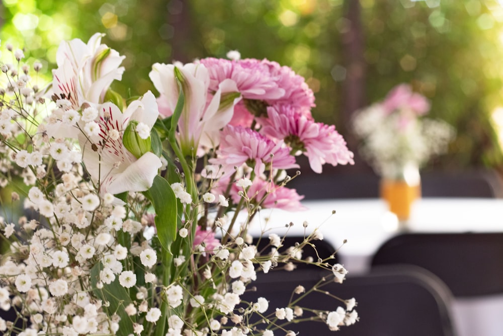 a vase filled with pink and white flowers