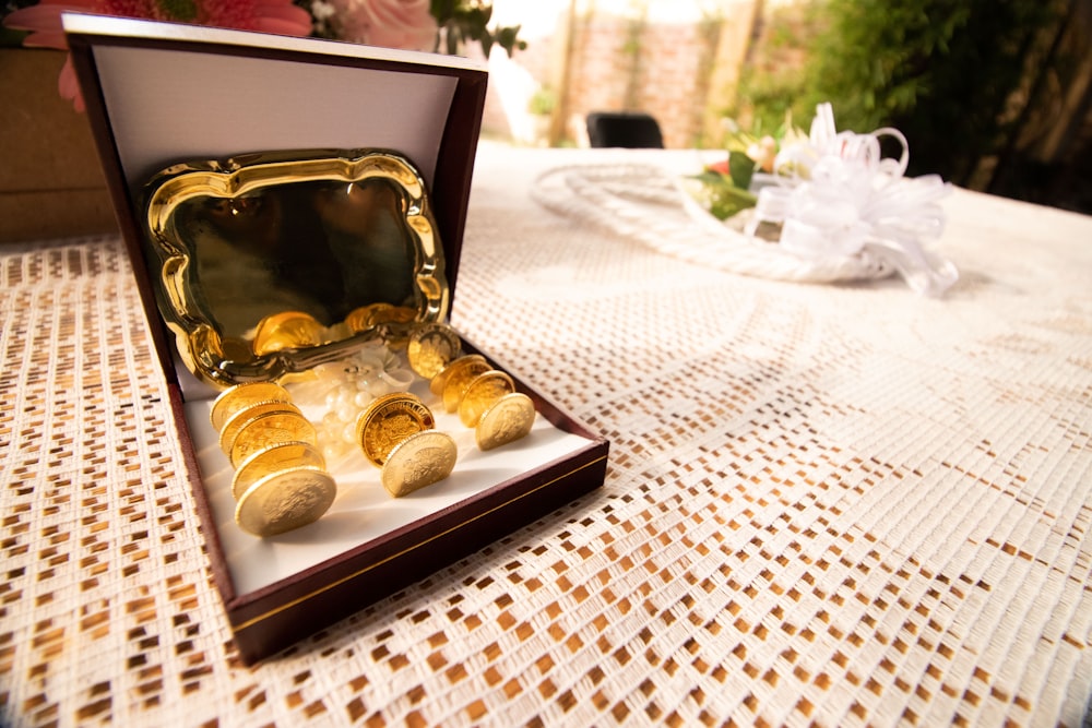 an open box of gold nuggets sitting on a table