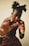 A person with a bold hairstyle featuring two puffs, adorned with gold earrings and bracelets, is captured in a dynamic pose. They appear to be in motion, with hands raised in front, partially obscuring the face. The attire includes a vibrant, patterned wrap or skirt.
