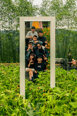 a group of people taking a picture in a mirror
