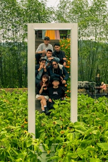 a group of people taking a picture in a mirror