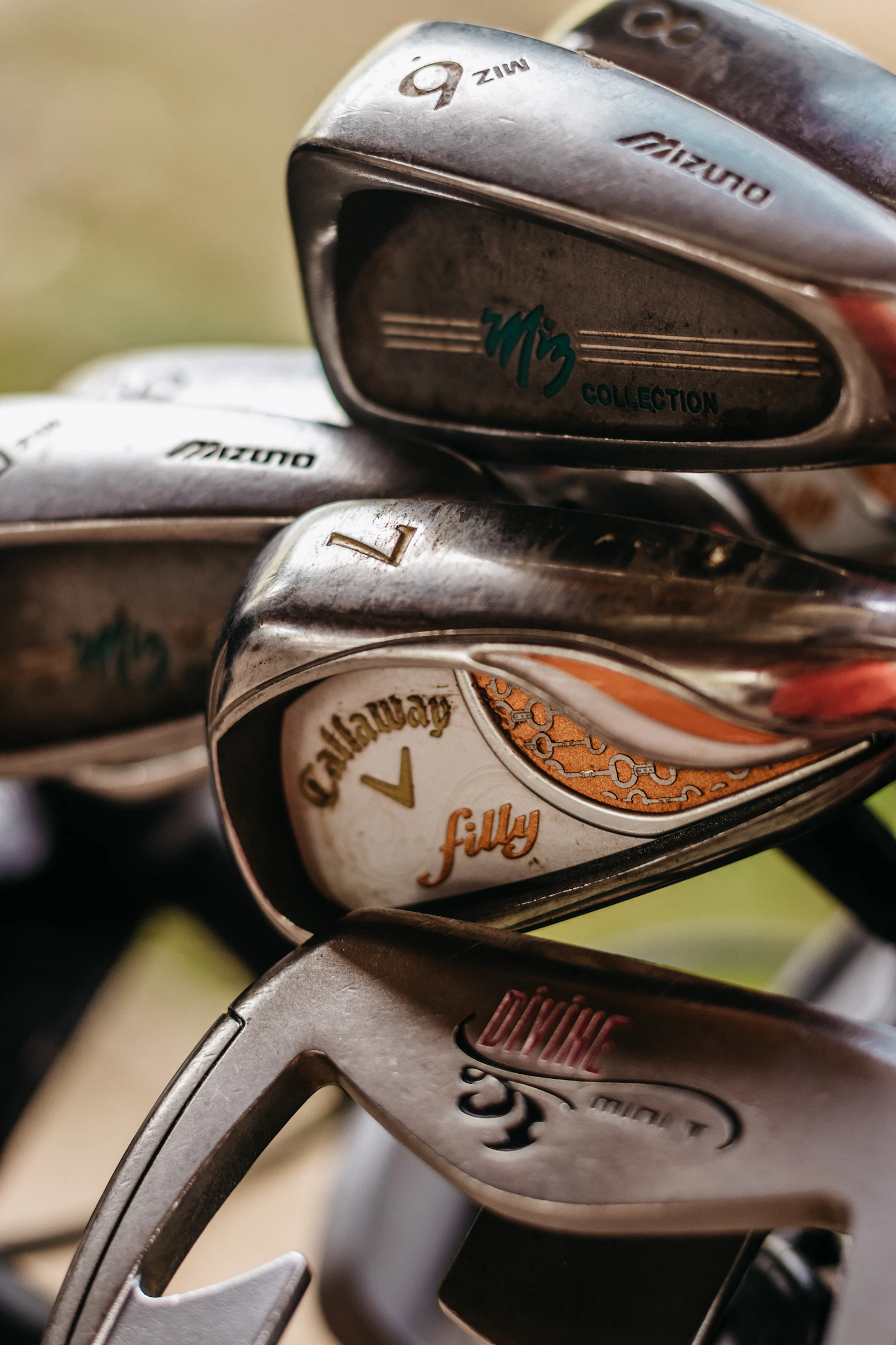 Assorted golf iron clubheads in a golf bag