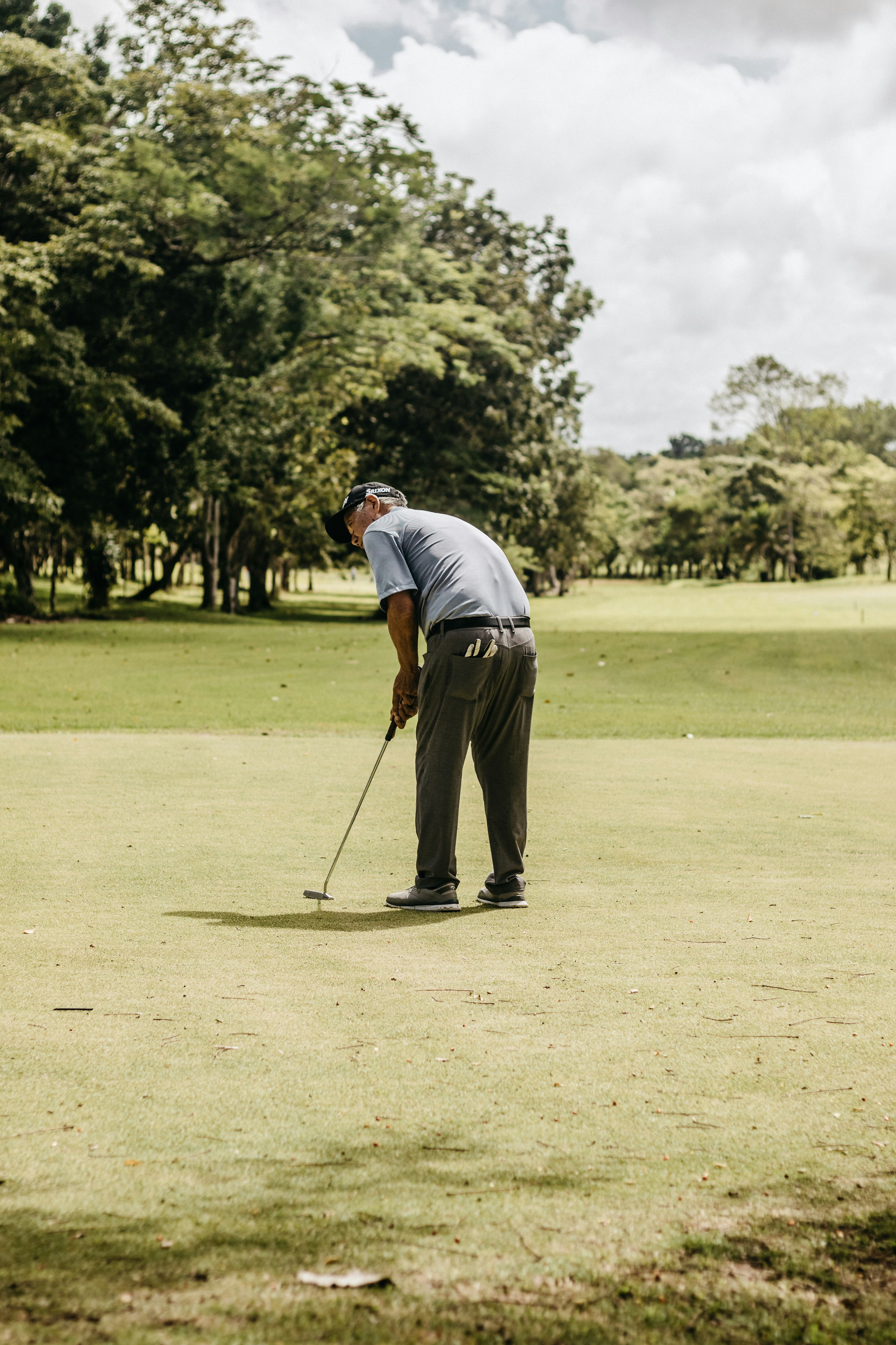 A man playing golf on a golf course photo Free Person Image on Unsplash