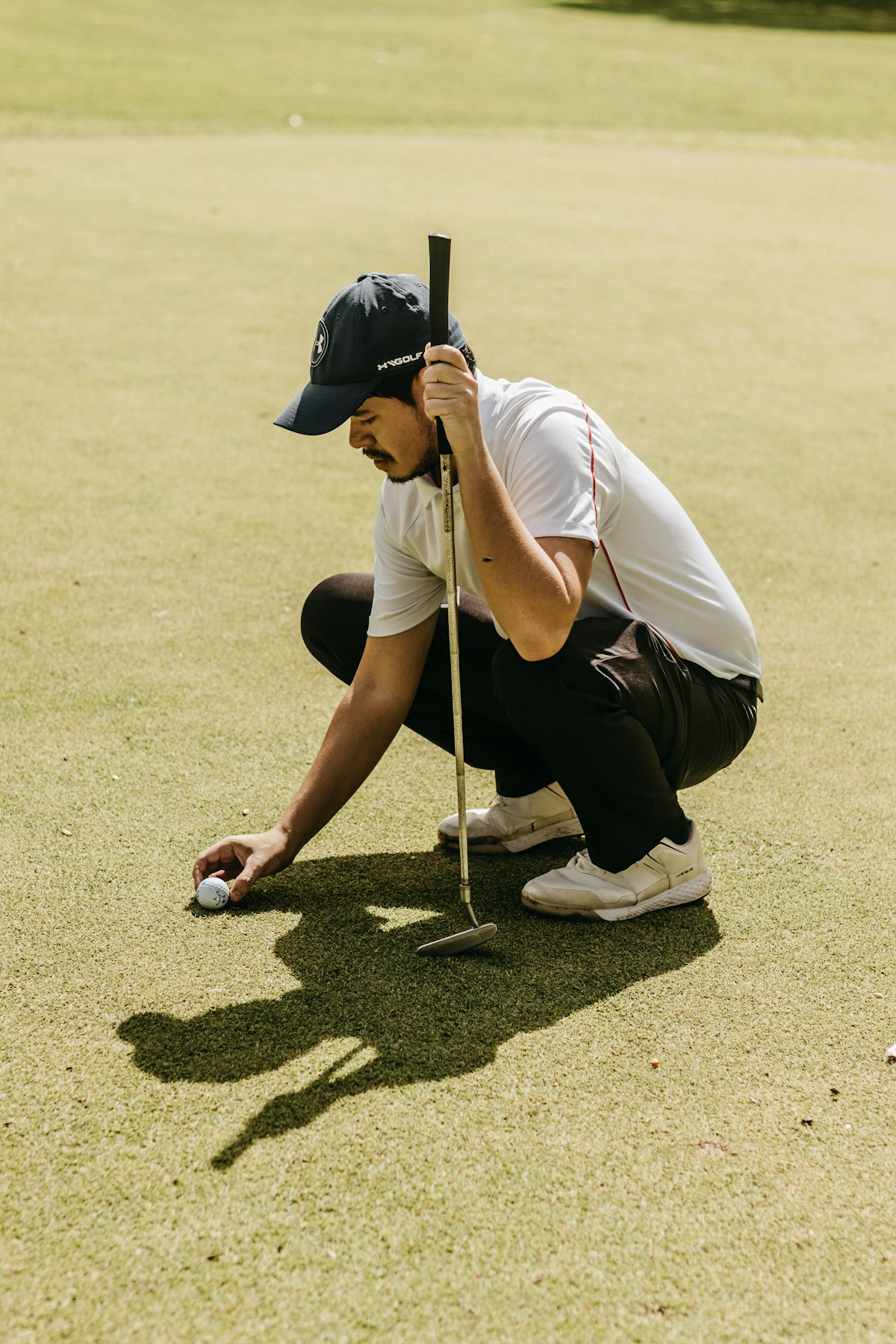 Close up of high-performance spikeless golf shoes on turf