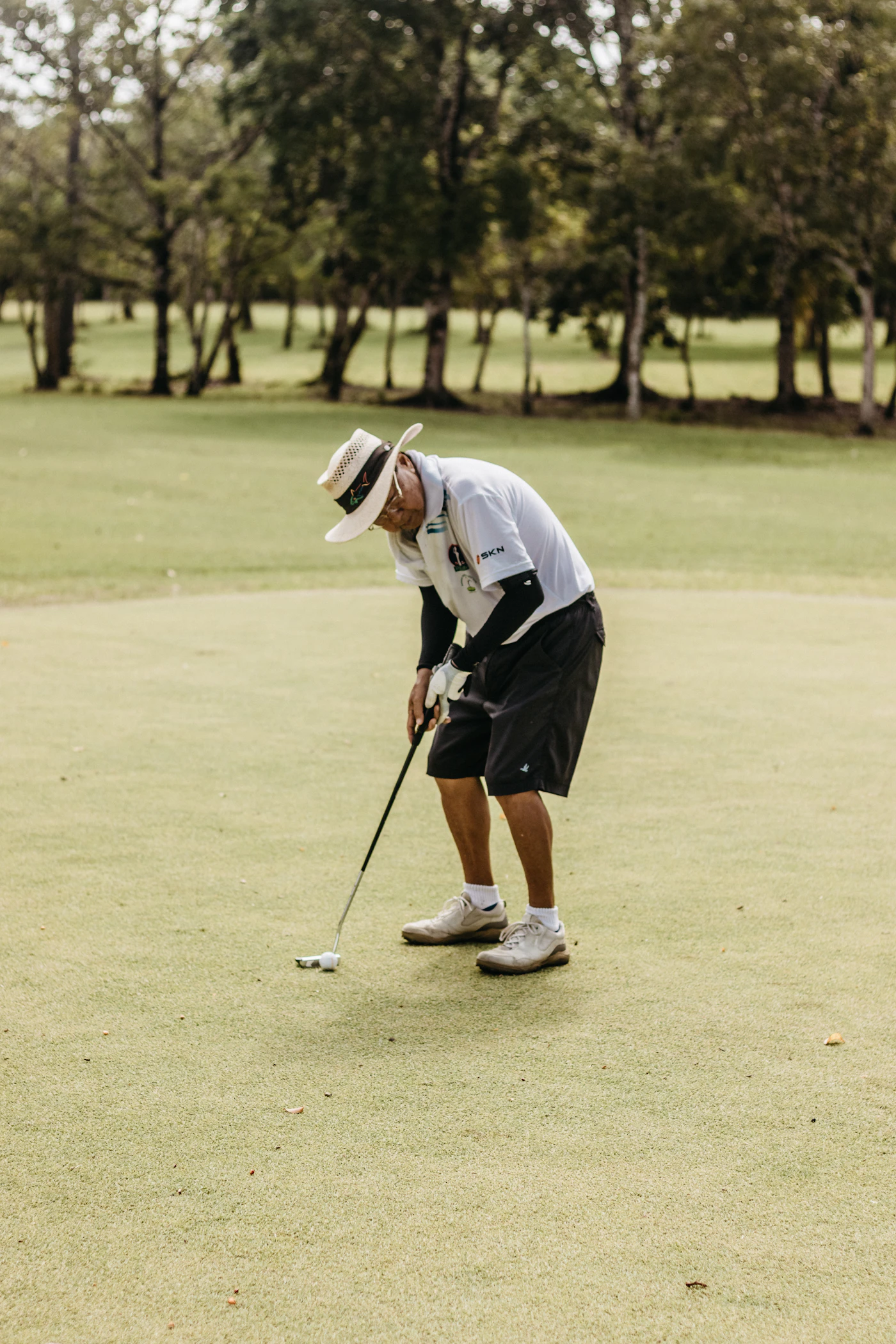 Mature man mid golf swing — joints performing