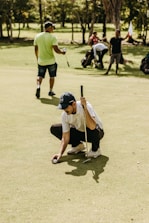 a man kneeling down holding a baseball bat