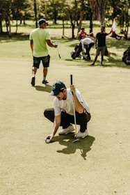 a man kneeling down holding a baseball bat