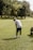 a man standing on top of a lush green field