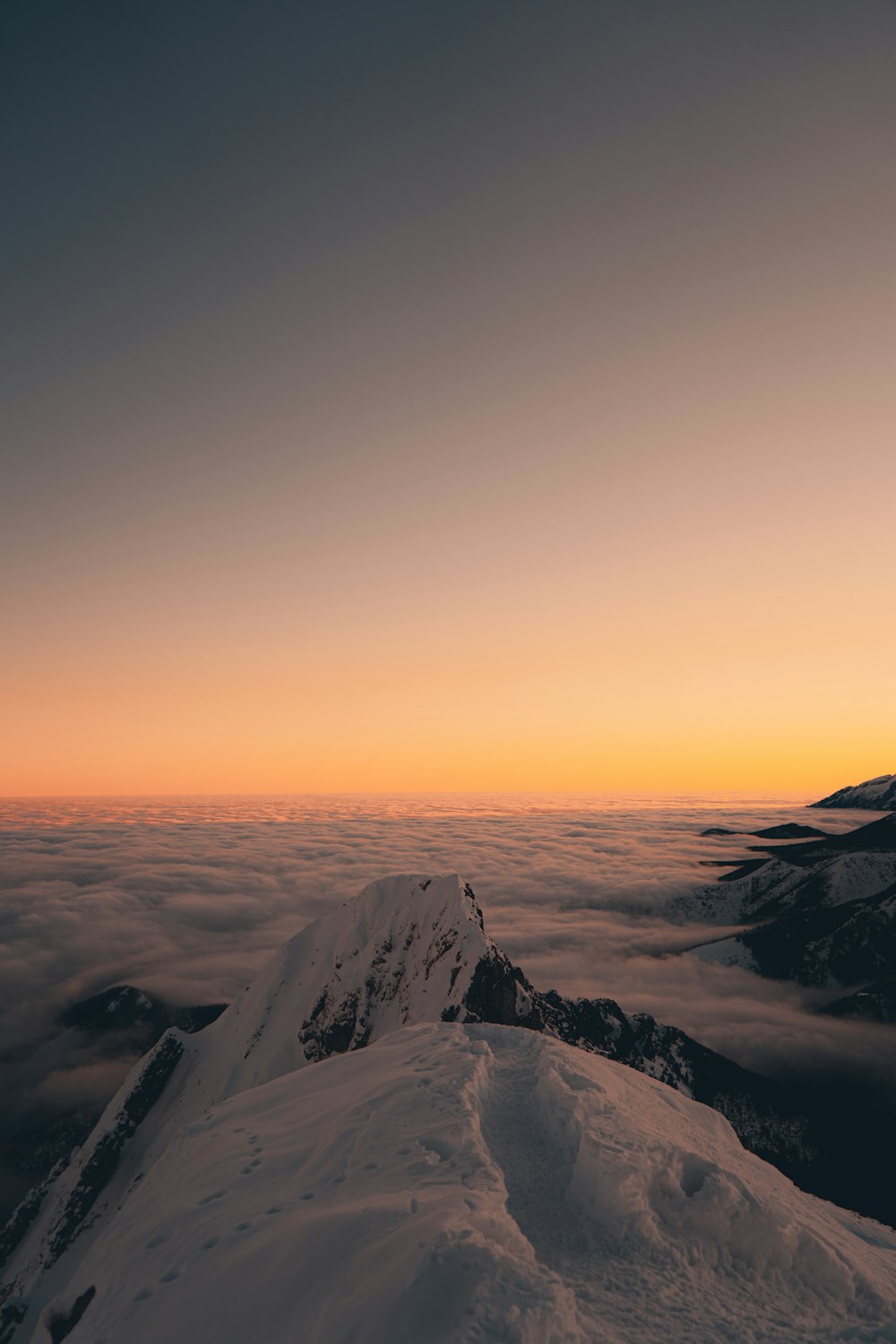 a mountain covered in snow with a sky background