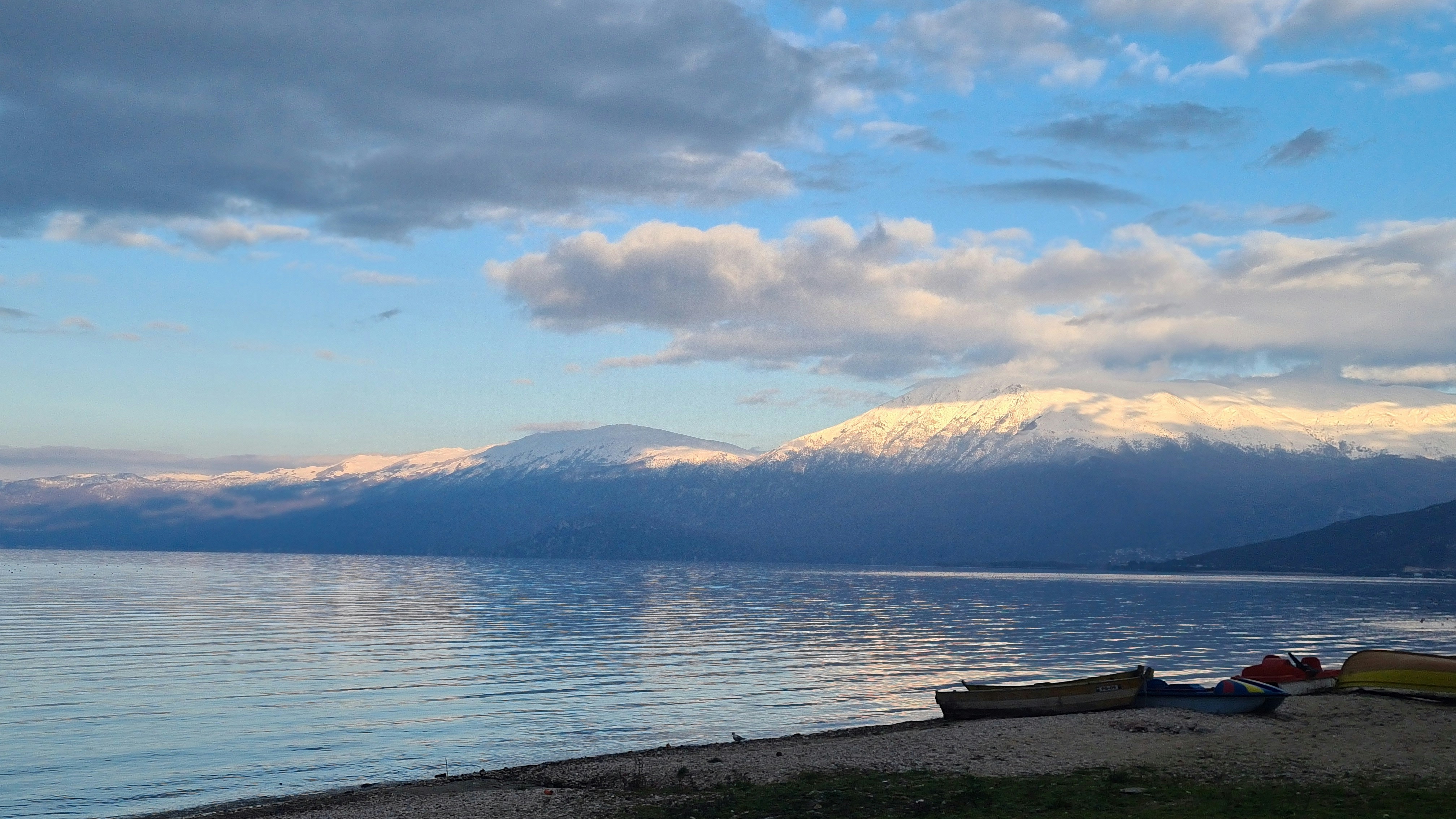 Crystal clear waters and scenic backdrop of Lake Ohrid at sunrise