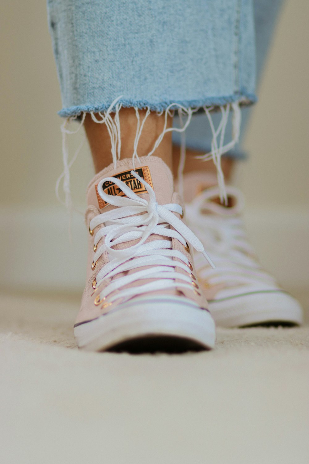 a pair of pink sneakers with white laces