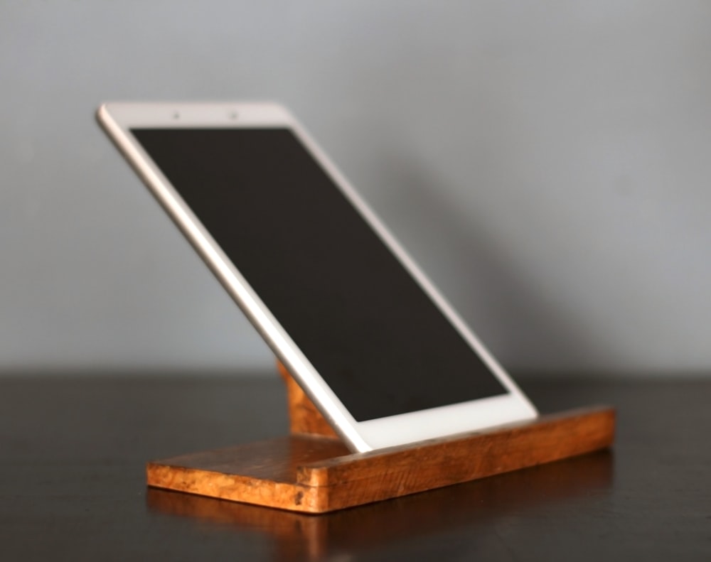 a cell phone sitting on top of a wooden stand