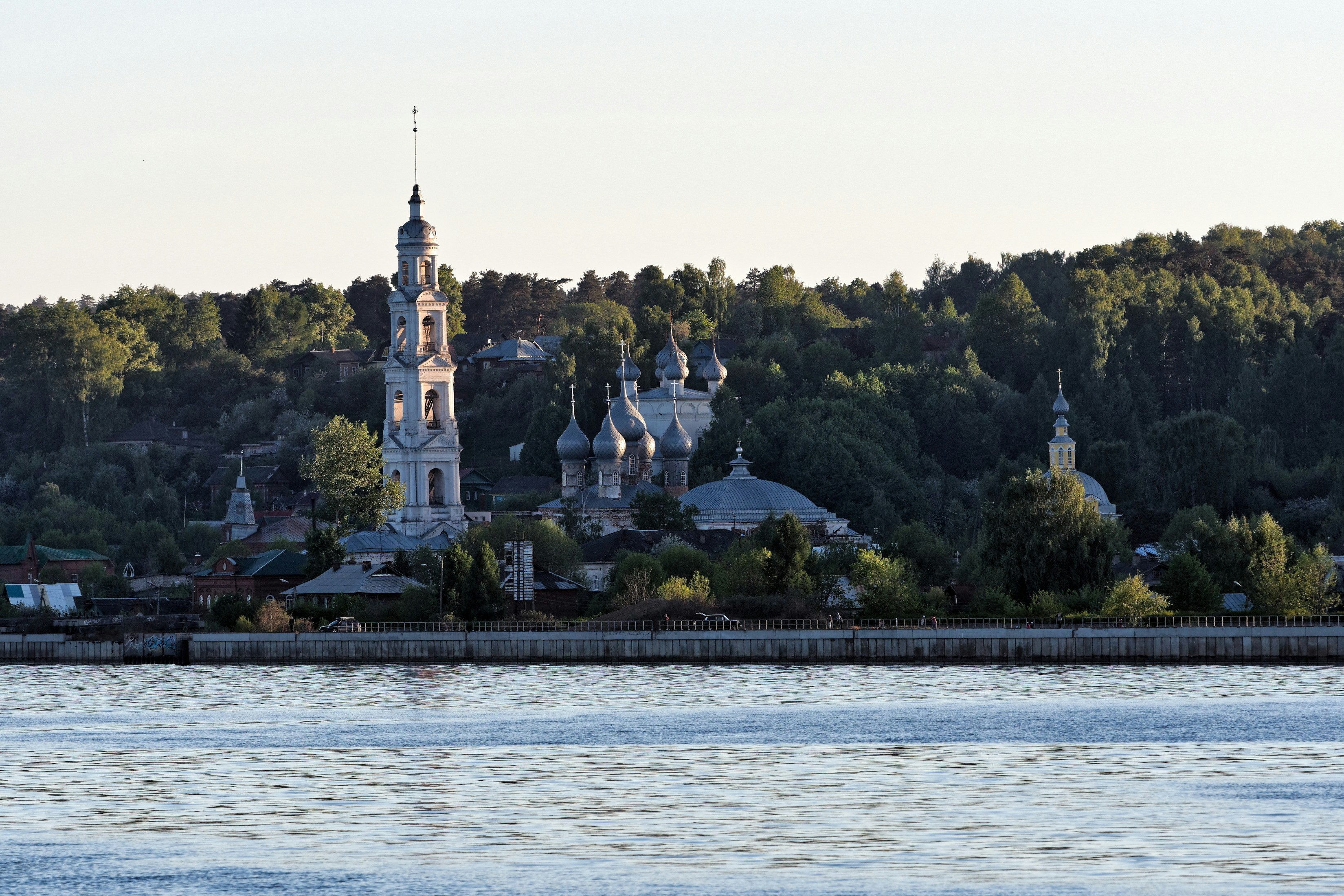 a large body of water with a church in the background