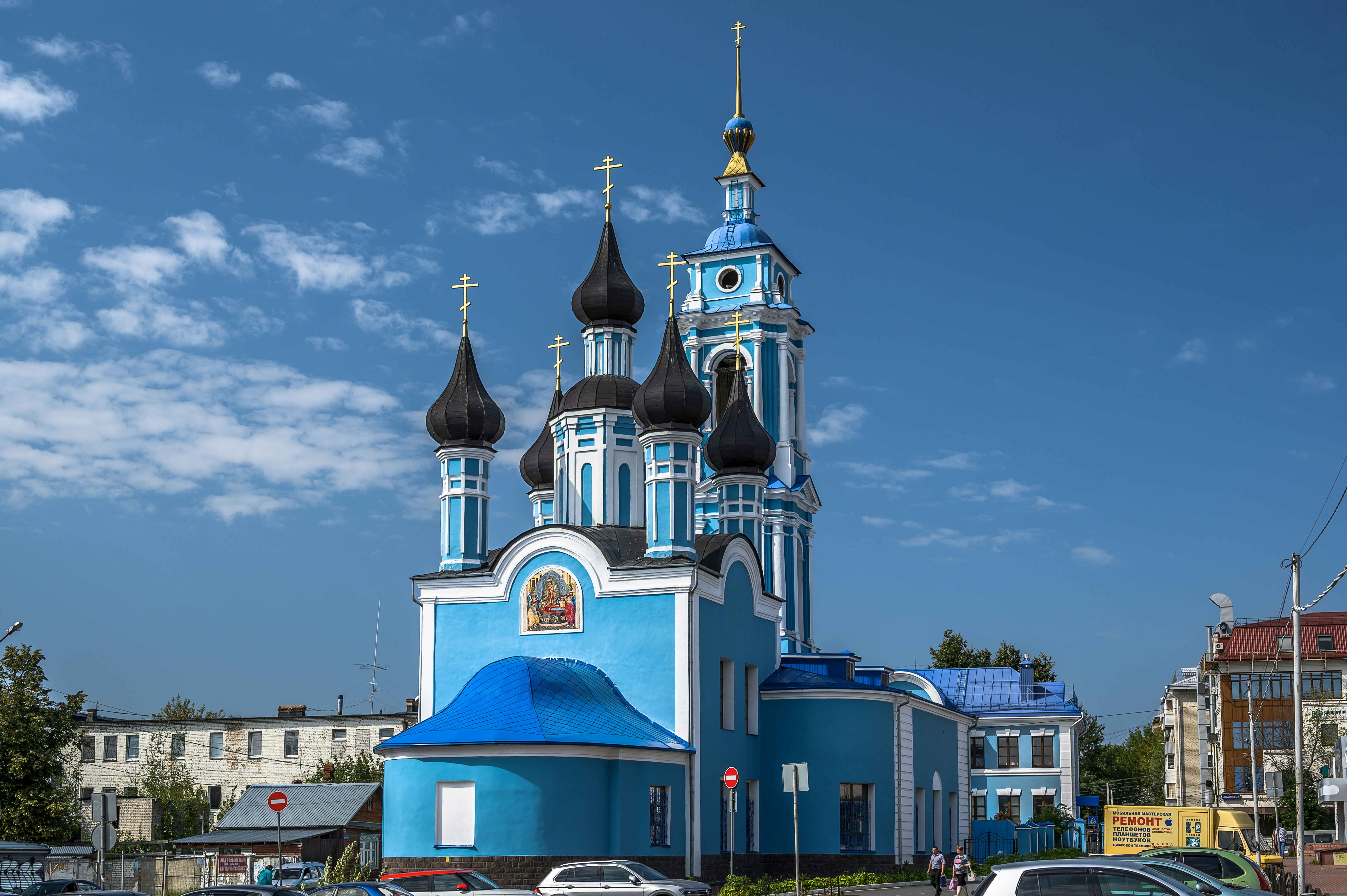 a blue and white church with a blue roof