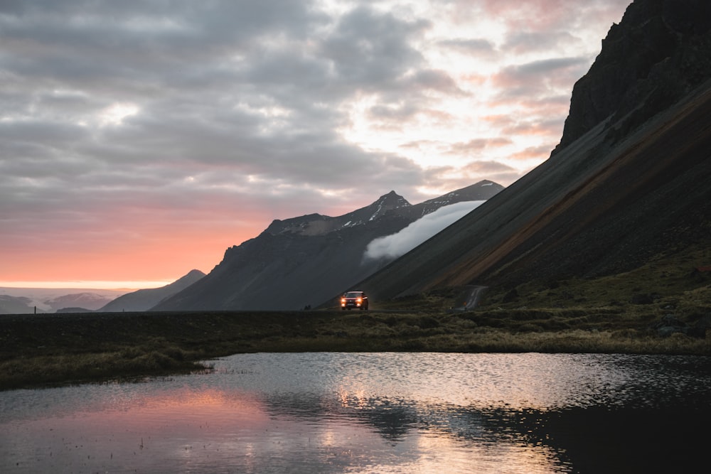 a body of water with a mountain in the background