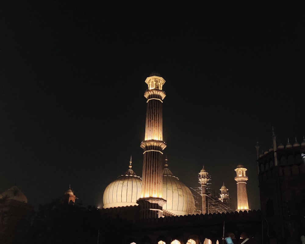 a large building with a very tall tower at night