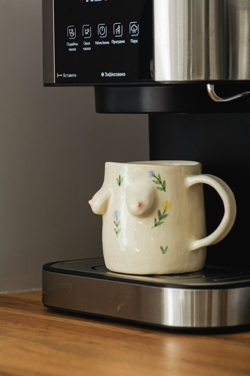 a coffee cup sitting on top of a coffee maker
