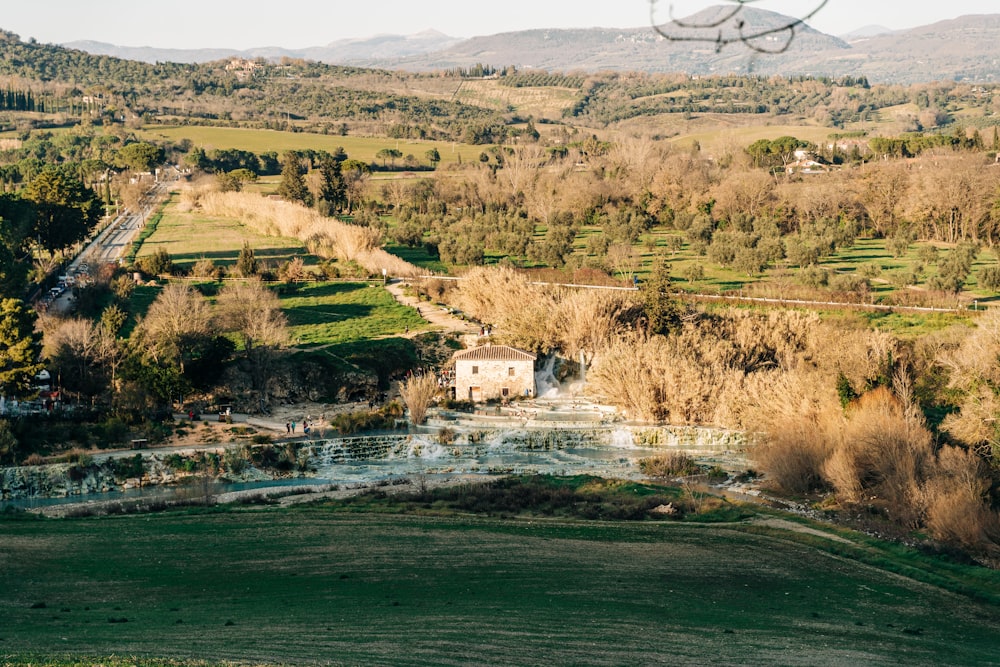 an aerial view of a farm in the mountains