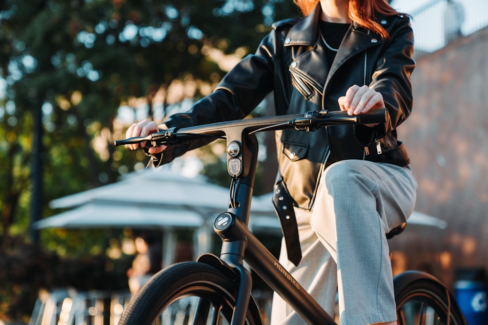 a woman riding a bike down a street