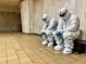 three people in white suits sitting on a bench