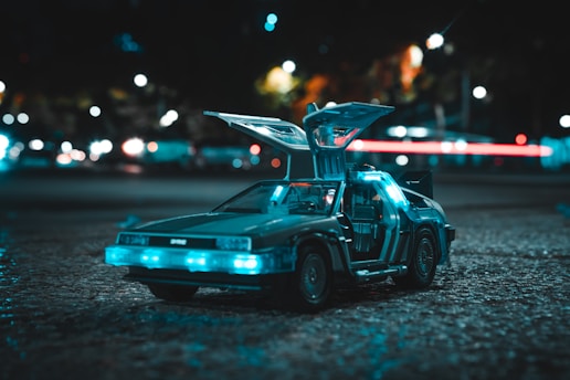 a toy car with its hood open sitting on the ground