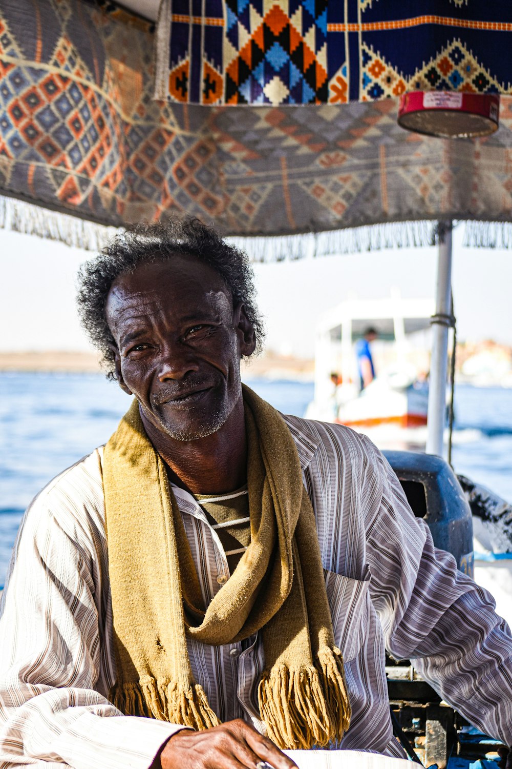 a man sitting on a boat in the water