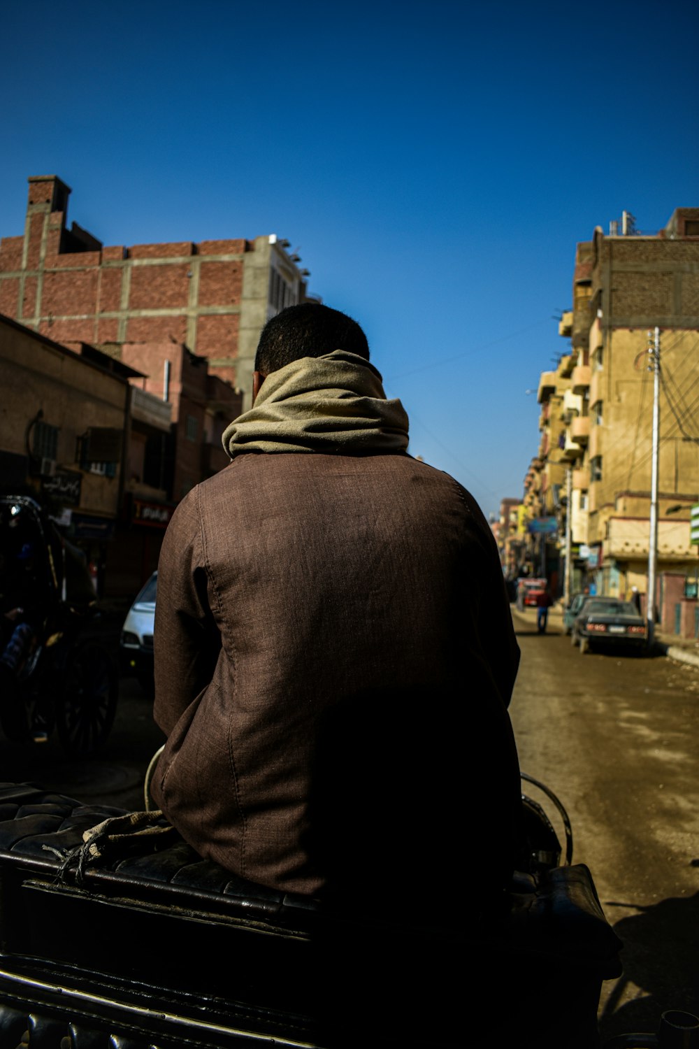 a man riding a motorcycle down a street