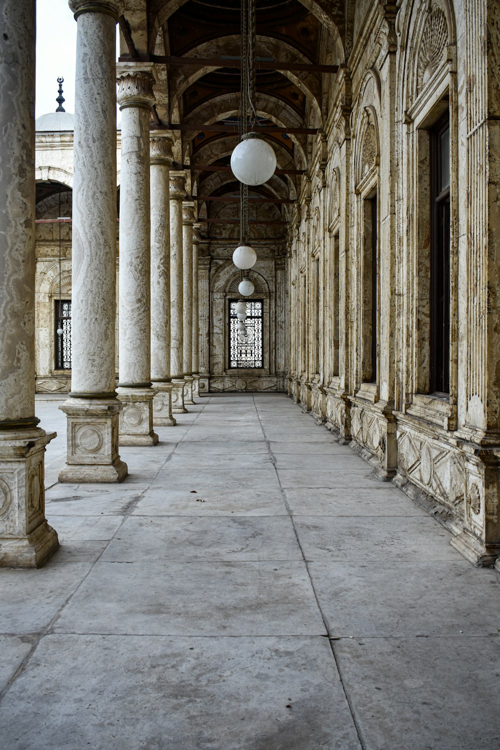 an old building with columns and a clock on the wall