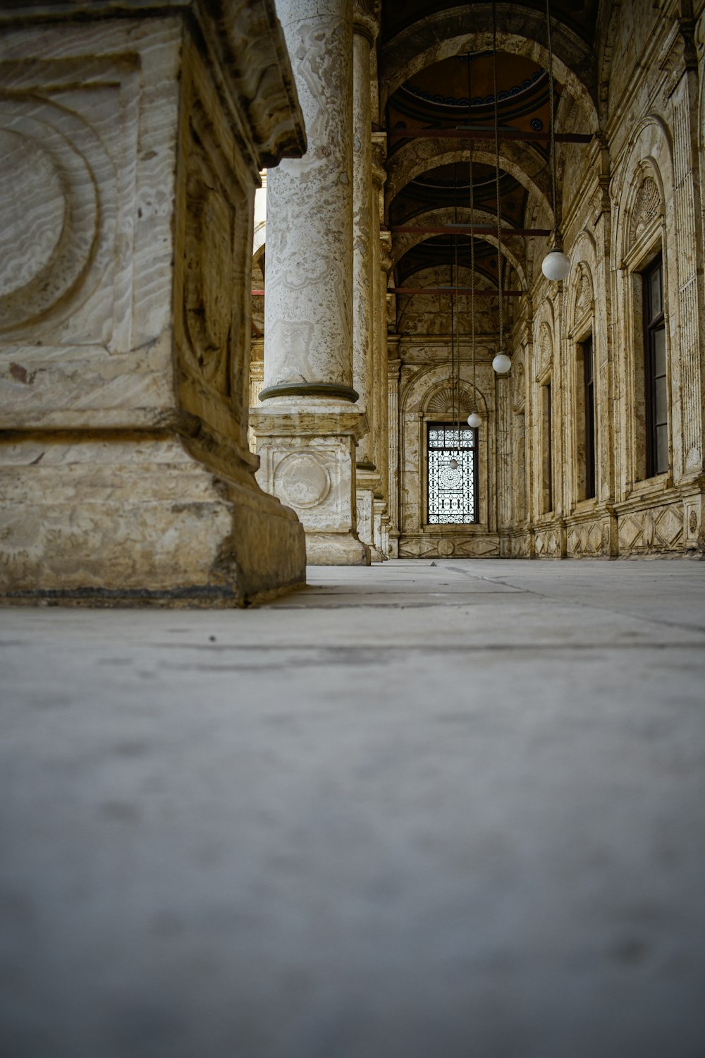 a large building with columns and a clock on the wall