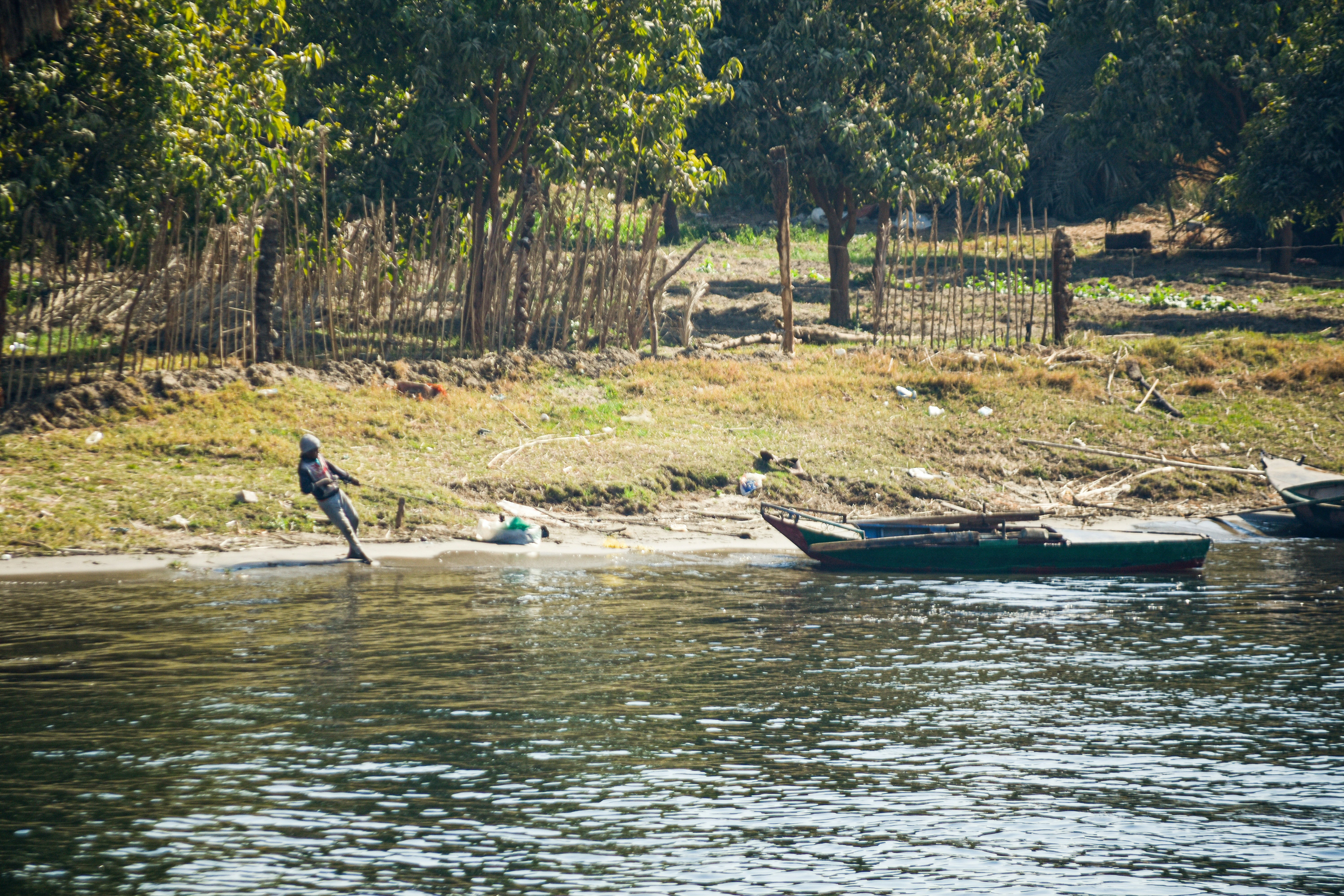 a couple of boats floating on top of a river, 