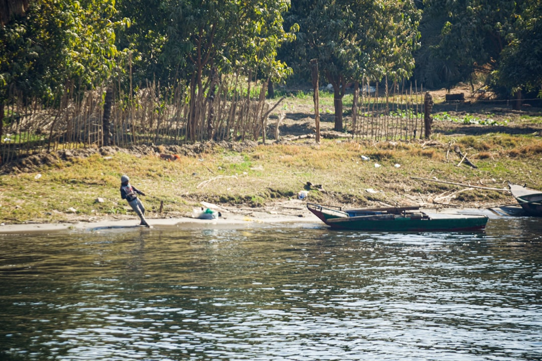 a couple of boats floating on top of a river,