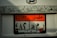 A close-up view of a car's license plate featuring English and Arabic text. The rectangular plate has a prominent orange and white color scheme with the word 'EGYPT' at the top. Decorative art with a skull motif frames the plate above. Below the plate, there is a 'Skunk Racing' logo.