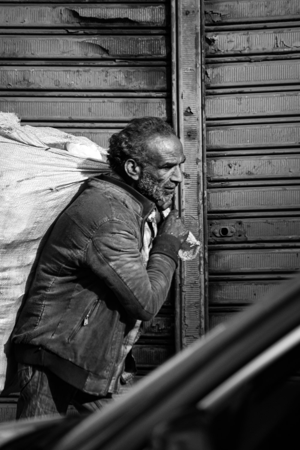 a black and white photo of a man smoking a cigarette