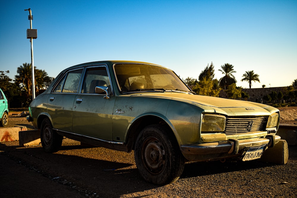 an old car is parked next to a green car