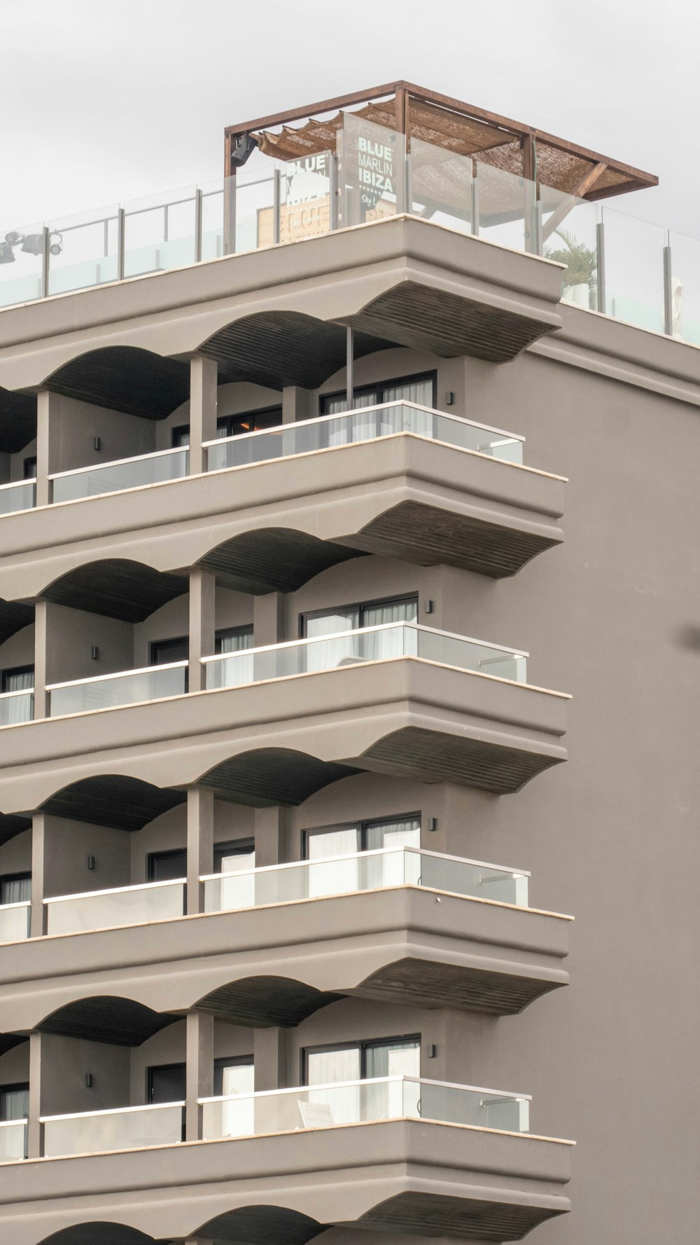 a tall building with balconies and balconies on top