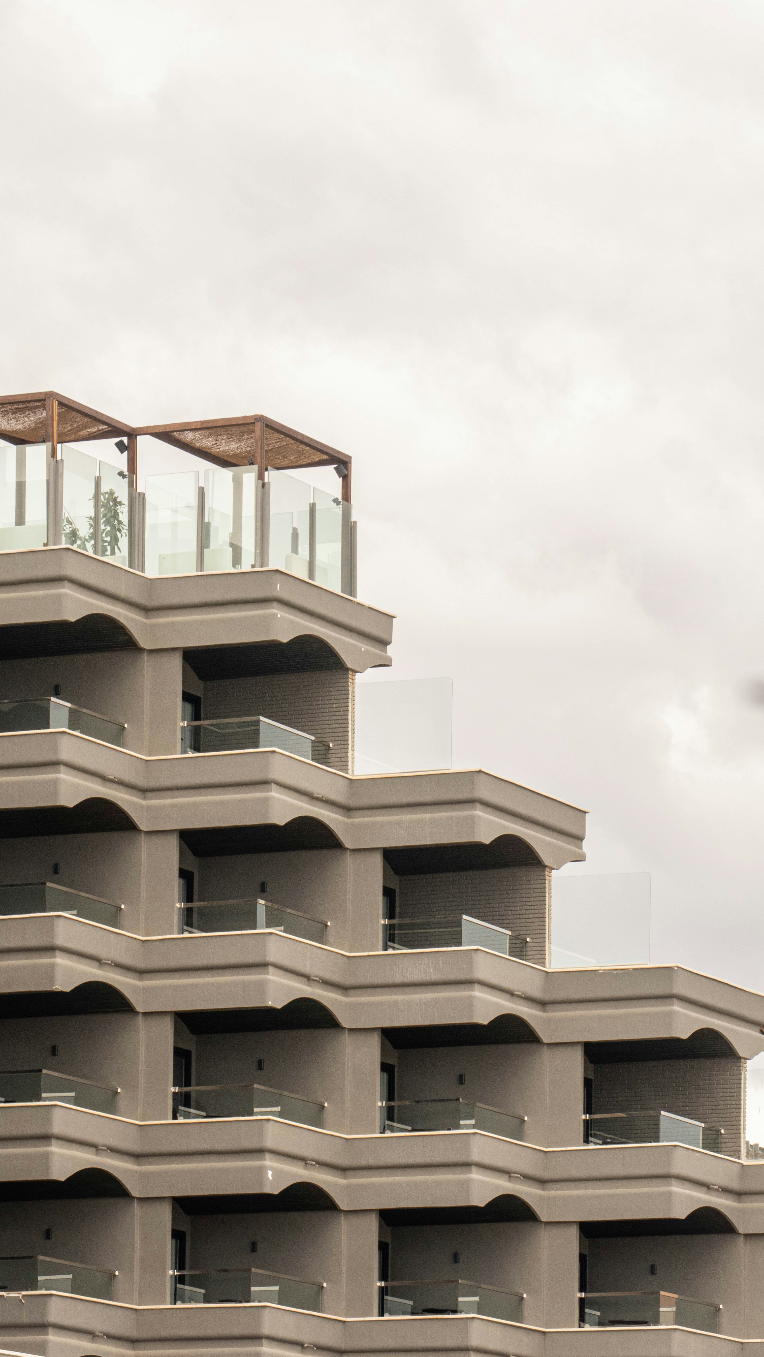 a tall building with balconies on top of it