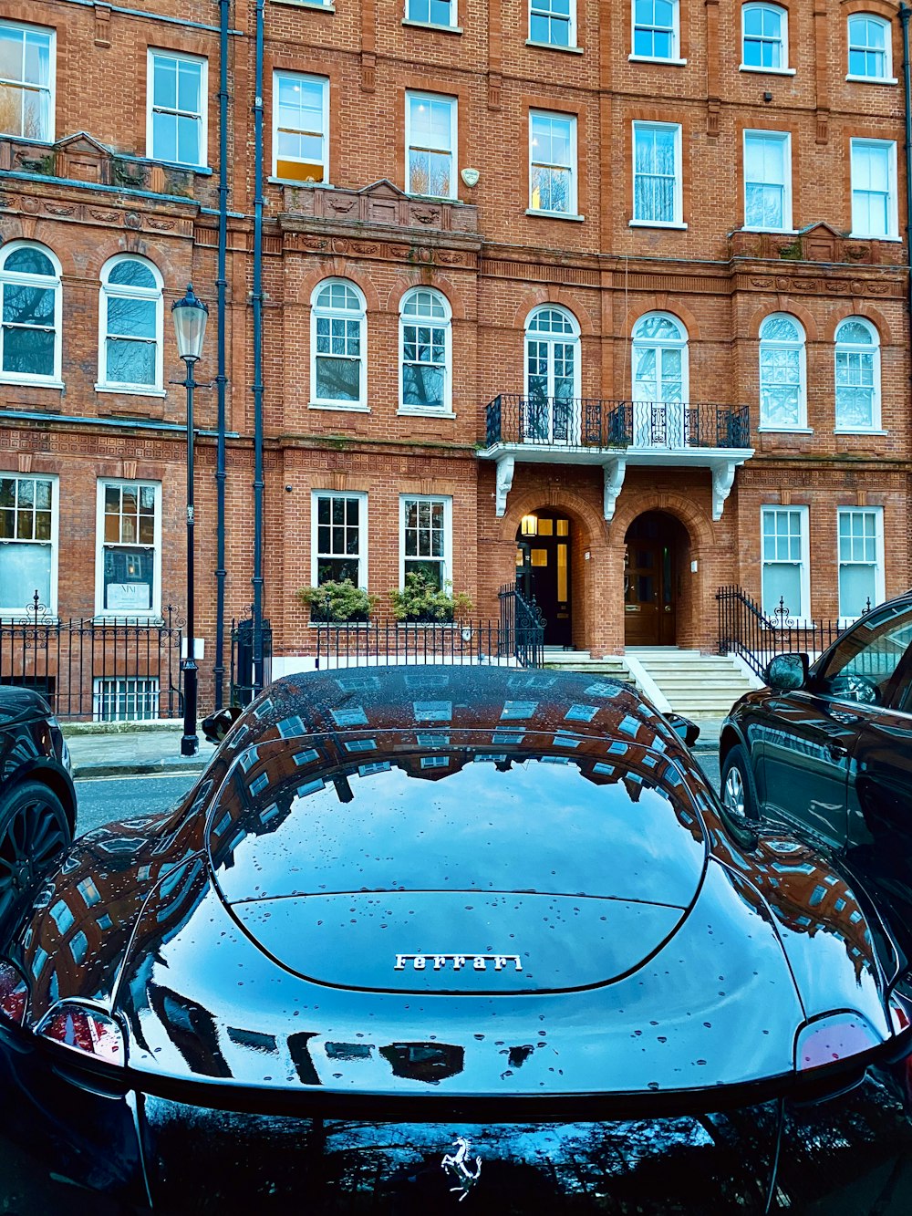 a black sports car parked in front of a building
