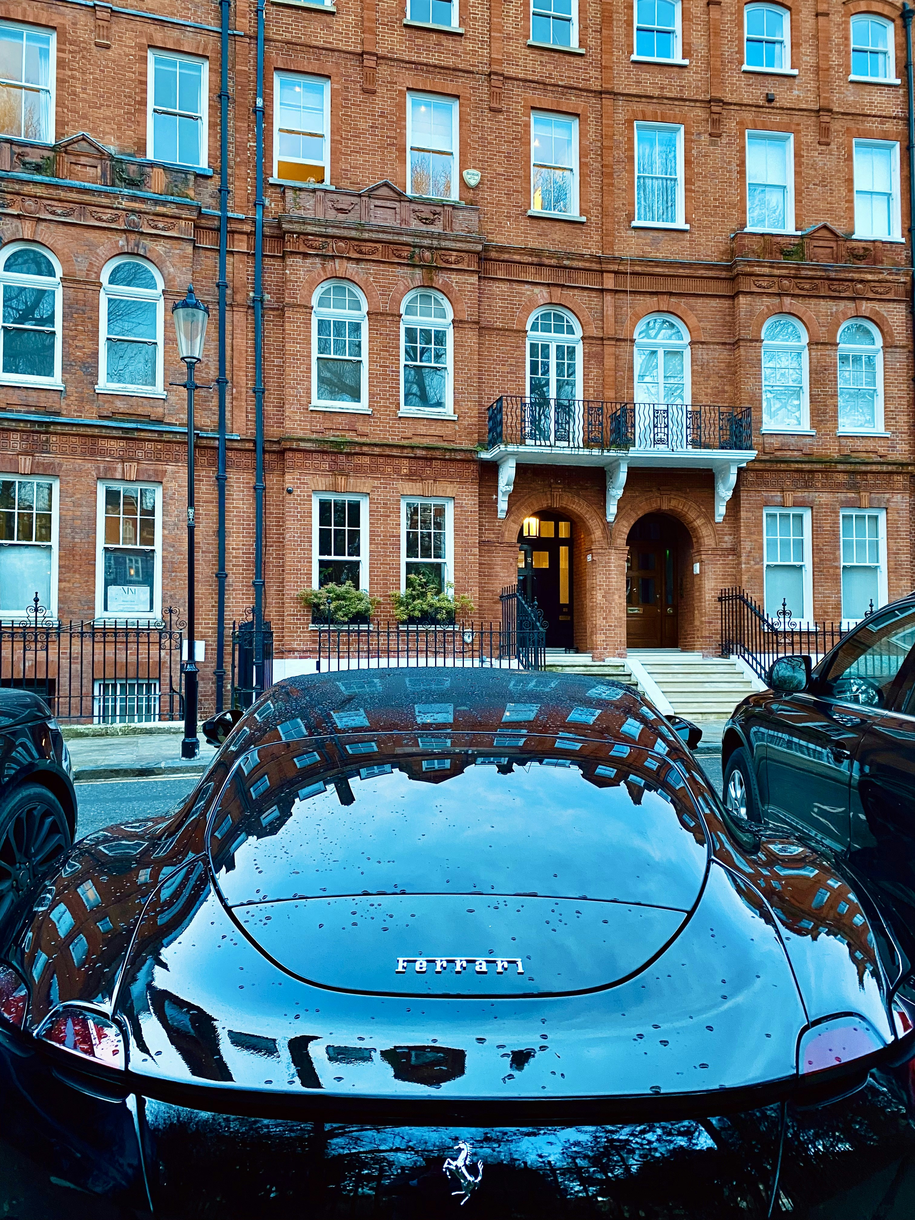 motor vehicles - dark horse power in waiting - parked Ferrari in Chelsea, London, UK