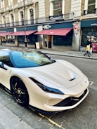 a white sports car parked on the side of the road