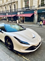 a white sports car parked on the side of the road