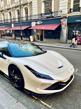 a white sports car parked on the side of the road