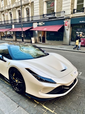 a white sports car parked on the side of the road