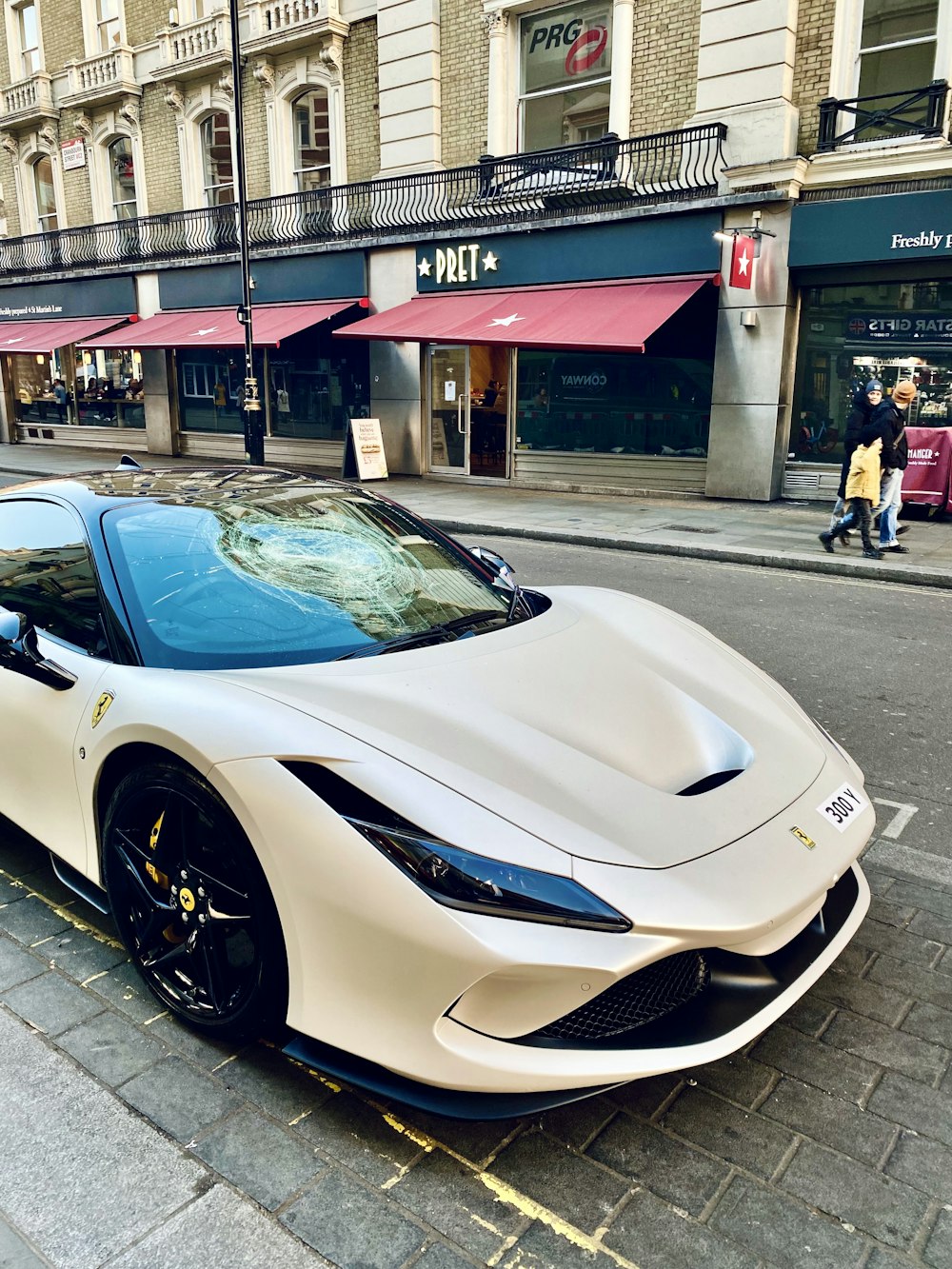 a white sports car parked on the side of the road