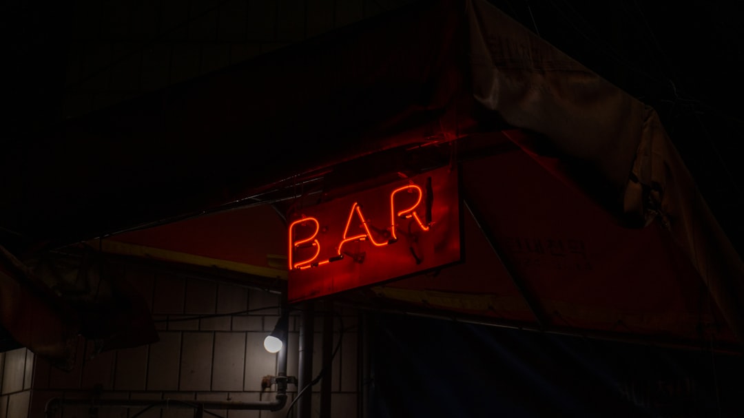 a red neon sign that says bar on it, Sony a5000