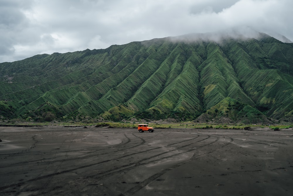 a truck is parked in front of a mountain