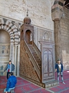 Side view of a traditional mosque pulpit showcasing elegant woodwork.